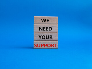 We need your support symbol. Wooden blocks with words We need your support. Beautiful blue background. Business and We need your support concept. Copy space.