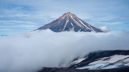 A beautiful view of Koryaksky Volcano in clouds. Kamchatka