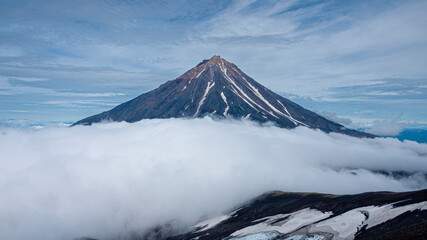 A beautiful view of Koryaksky Volcano in clouds. Kamchatka