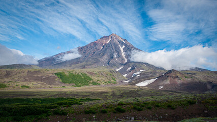 A beautiful view of Koryaksky Volcano, in clouds and green moss. 