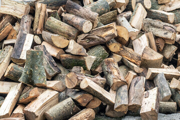 A pile of sawed firewood for heating in winter. Stockpile of firewood during the energy crisis