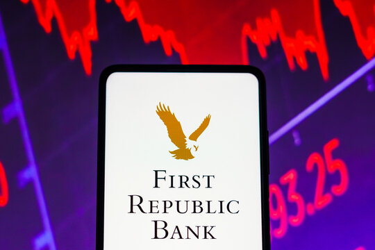 March 15, 2023, Brazil. In this photo illustration the First Republic Bank logo seen displayed on a smartphone screen, with graphic representation of the stock market in the background.