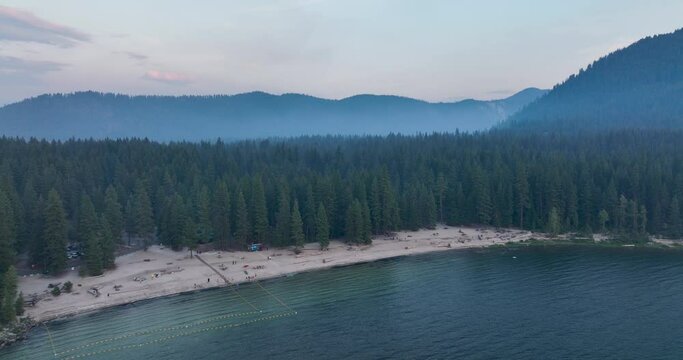 Lake Wenatchee State Park Washington USA Aerial Overview of Sandy Beach Shore and Mountainous Forests at Dusk on Summer Day