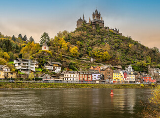 Cochem village colourful houses on on moselle river and the castle on mountain top during autumn, Germany