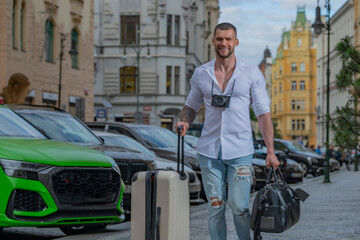 Fototapeta na wymiar Traveler student or young tourist. Male traveler with suitcase outdoor. Portrait of young caucasian man in shirt on summer vacation.