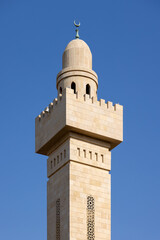 Fototapeta premium Minaret of the mosque against blue skies in Abu Dhabi, UAE