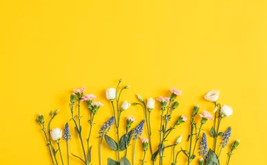 Papier Peint photo Lavable Prairie, marais Flowers composition on a bright yellow trendy background. Floral background. Backdrop for children’s Day. Text space 