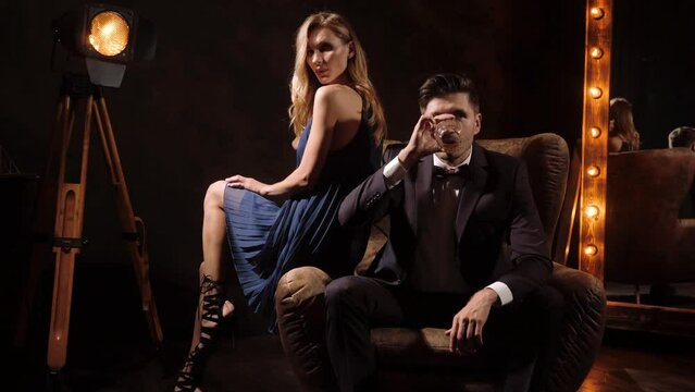 Brutal Attractive young guy and Sexy blonde girl. Seduce a man. Couple in love. Temptation. passion. Flirting.
