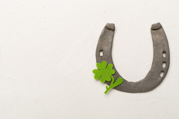 Horseshoe with clover on concrete background, top view. St. Patricks day concept