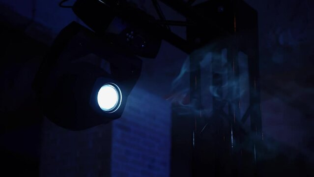 Moving head, generic and LED fixtures. Smoke in the rays of light. Stage lighting work in a dark atmosphere at a concert or show