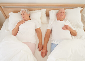 Lifetime of togetherness. High angle shot of a senior couple asleep in bed.