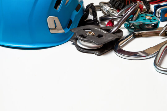 Helmet for work at height or mountaineering. Equipment for mountaineering and high-altitude works. carabiners, pulleys, belts. Close-up. on a white background. Empty place.
