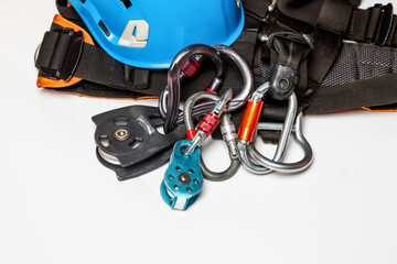 Helmet for work at height or mountaineering. Equipment for mountaineering and high-altitude works. carabiners, close-up. on a white background. Empty place.