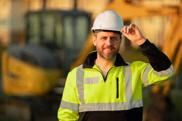 Builder at building site. Construction manager in helmet. Male construction engineer. Architect at...