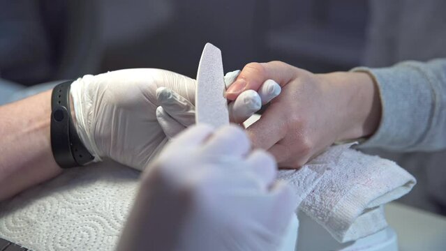 shortening the natural nail with a paper file