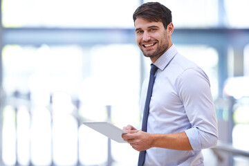 Fototapeta premium The modern work desk. A young professional businessman holding a digital tablet.