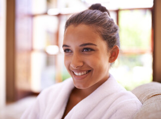 Her mood was instantly brightened. a young woman in a bathrobe at a health spa.
