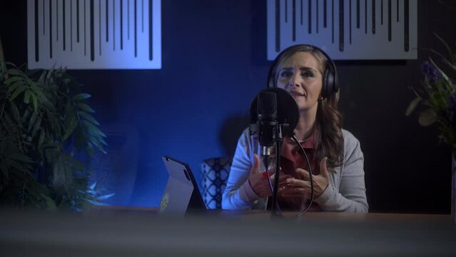 Female entrepreneur streamer recording her online podcast in her studio