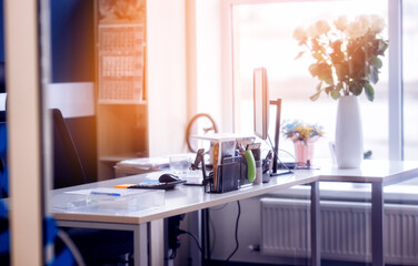 Stylish workspace with desktop computer, office supplies, houseplant and flowers at office. desk work concept.