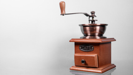 Traditional wooden coffee mill grinder over white background