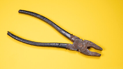Old rusty pliers on a plain white background
