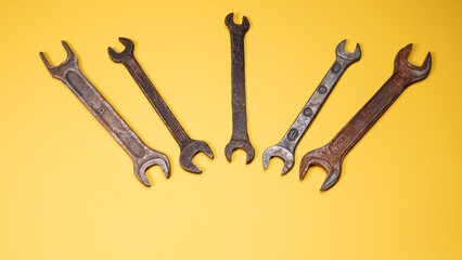 Old wrenches on a yellow background metal and rusty wrench isolated on yellow background.An old rusty wrench on a white background. Vintage wrench close-up.
