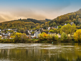 Fototapeta na wymiar Sehl village on Moselle river during autumn with colourful trees in Cochem-Zell district in Rhineland-Palatinate, Germany