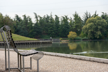 Empty bench by the lake during the pandemic