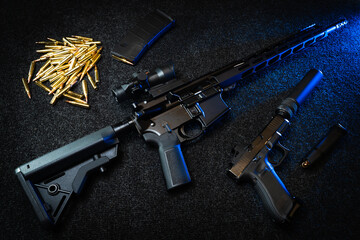 Firearms, ar 15 rifle with scope and silenced pistol.