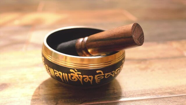 Tibetan bowl on a wooden table during sound healing ceremony in Tulum 