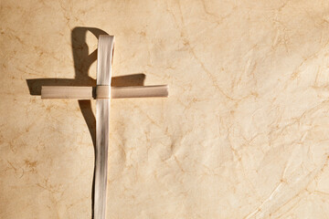 Palm sunday background. Cross from palm leaves on vintage background.