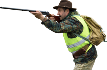 Hunting period, autumn season open. A hunter with a gun in his hands in hunting clothes in the autumn forest in search of a trophy. A man stands with weapons and hunting dogs tracking down the game.