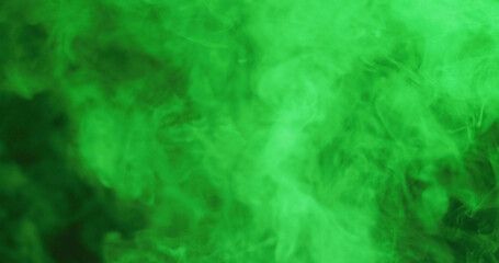 Fototapeta na wymiar Close up of clouds of green smoke with copy space background