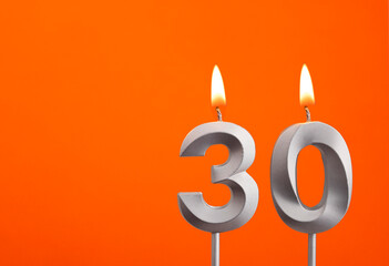 Number 30 - Silver Anniversary candle on orange background