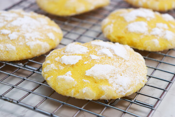 close up of delicious lemon cracked cookies with sugar powder on baking rack 