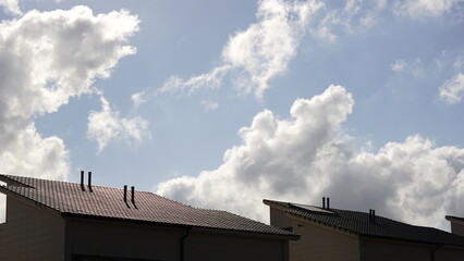 house roofs against cloudy sky