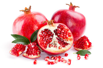 Food concept. Ripe pomegranate with leafs and seeds piece of garnet on white background