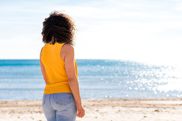 Unrecognizable woman enjoying sunny seascape