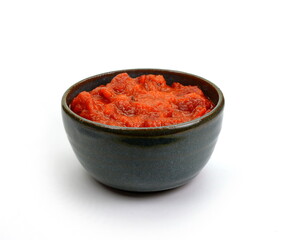 Adjika isolated on white background.  Hot chili and paprika sauce with garlic isolated on white background.