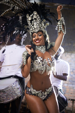 Glamourous dancing queen. a beautiful samba dancer performing in a carnival with her band.