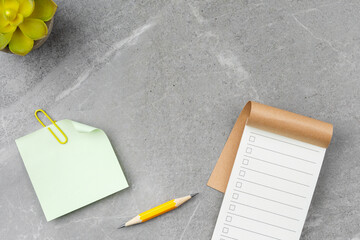 Open notebook on gray marble background.