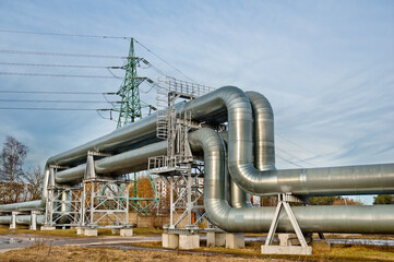 Fototapeta premium Power line tower and pipeline, gray sky in the background