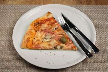 slice of pizza with ham and cheese on plate