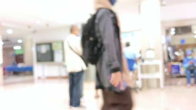 Time Lapse. Abstract Blur and Defocussed people at hospital taking line for making medical appointments assisted by customers service officer