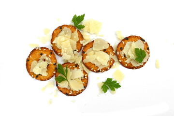 round crackers with parmigiano cheese flakes. 