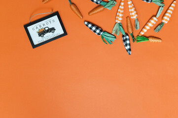 Easter Flat Lay with Carrots on orange background