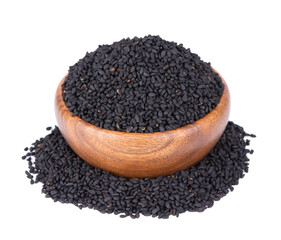 Black cumin seeds in wooden bowl, isolated on white background. Heap of black nigella seeds. Nigella sativa.