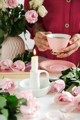 still life candle, flowers . selective focus. hand in frame concept