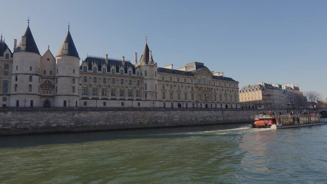 Castle Conciergerie - former royal palace and prison. Tourist boat sail nearby