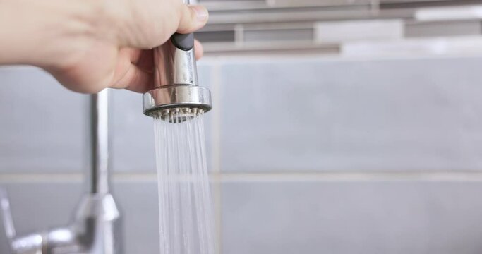 A person presses a button on the tap.